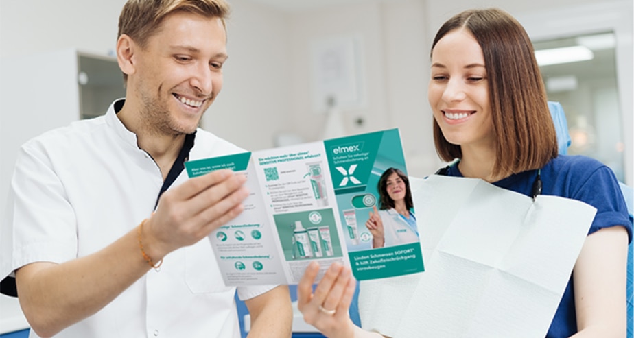 A dentist explains an X-ray to a patient