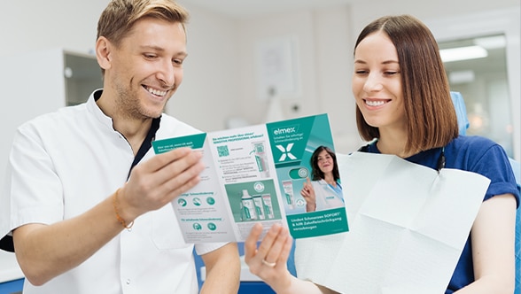 A dentist explains an X-ray to a patient